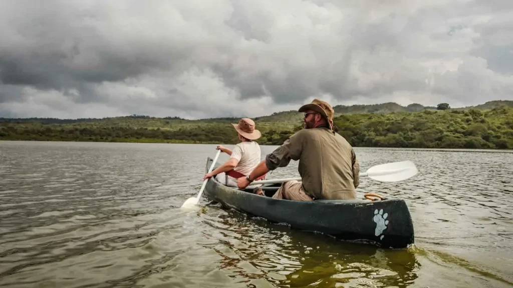 People paddling a canoe in a natural environment in Tanzania